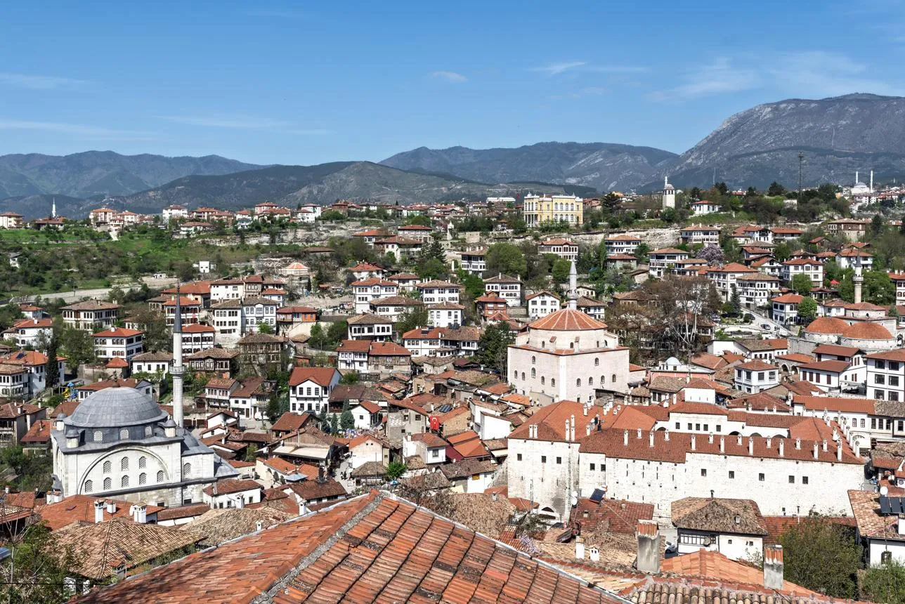 The red roofs, mosques and white Ottoman houses of Safranbolu below the mountains