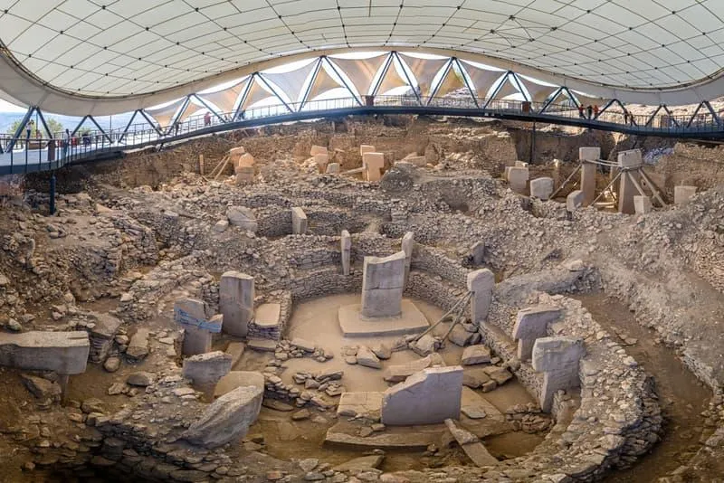 The stone enclosures and T-shaped pillars of Göbekli Tepe under the protective roof